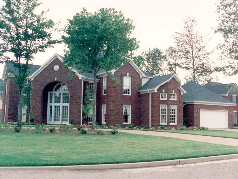 Two-Story Home With Grand Bay Window And Arched Entry