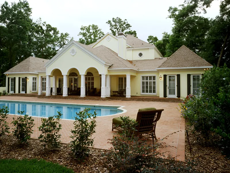 Gorgeous rear view includes pool and sprawling outdoor living area.