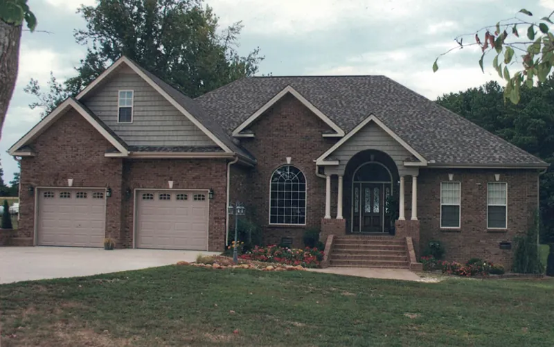 Traditional Brick Ranch Home Has Corner Quoins And Arched Front Entry