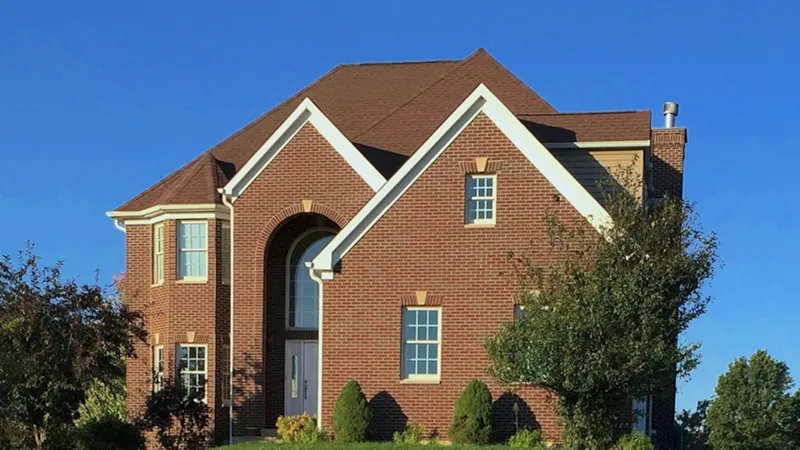 Home With Dramatic Arched Brick Entry