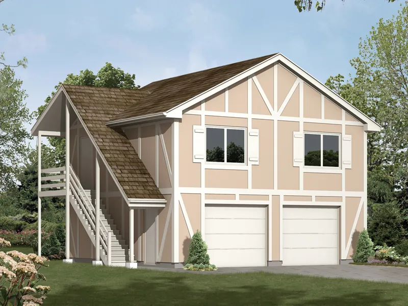 Two-story garage aprtment has side outdoor stairs and classic Tudor style trimwork