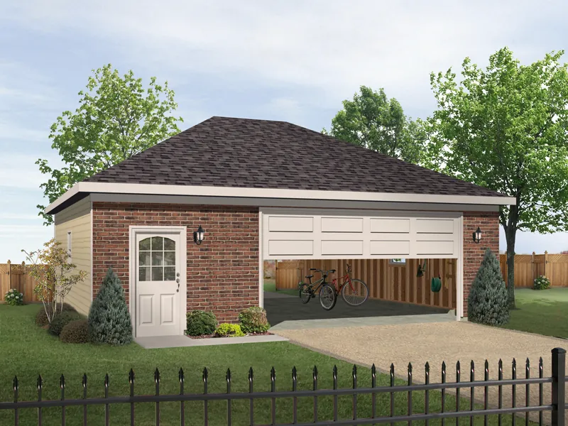 Two-car garage has hip roof design and entry door