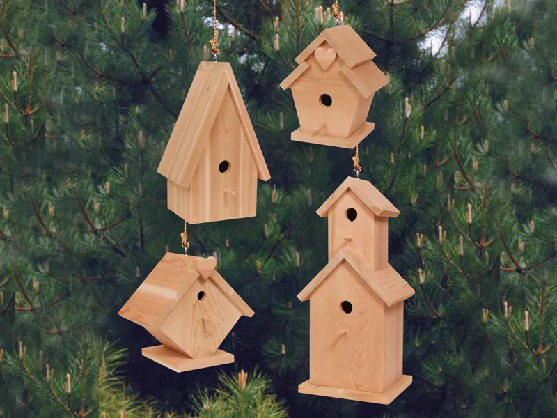 Four wooden birdhouses in multiple shapes and sizes that all look great together