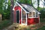 This stylish garden shed has a rustic exterior with sleek atrium windows and a French door entry