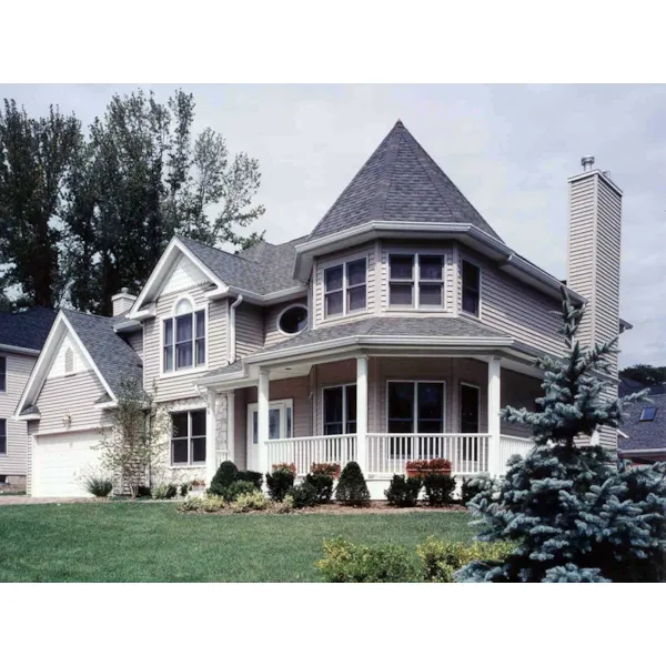 Victorian Style House With Striking Turret Wrapped By A Covered Porch