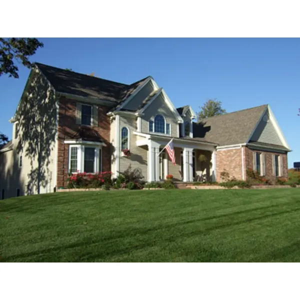 Charming Two-Story Home With Covered Porch, Bay Window And Trellis Style Arch Over Door 