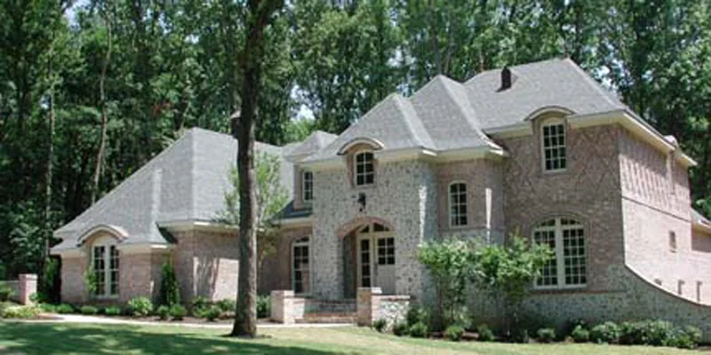 Two-Story Tudor Home With Brick Pattern details And Stonework