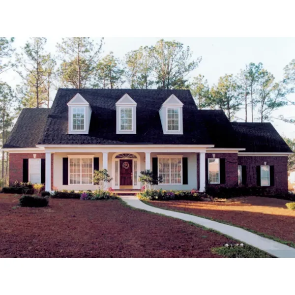 Brick Home With Sweeping Front Covered Porch And Triple Dormers