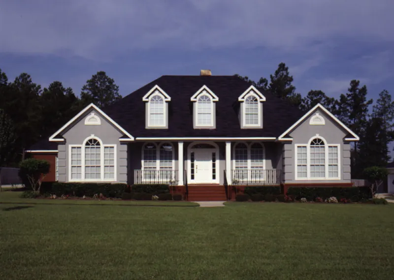 Symmetrical Home With Stately Front Porch And Windows