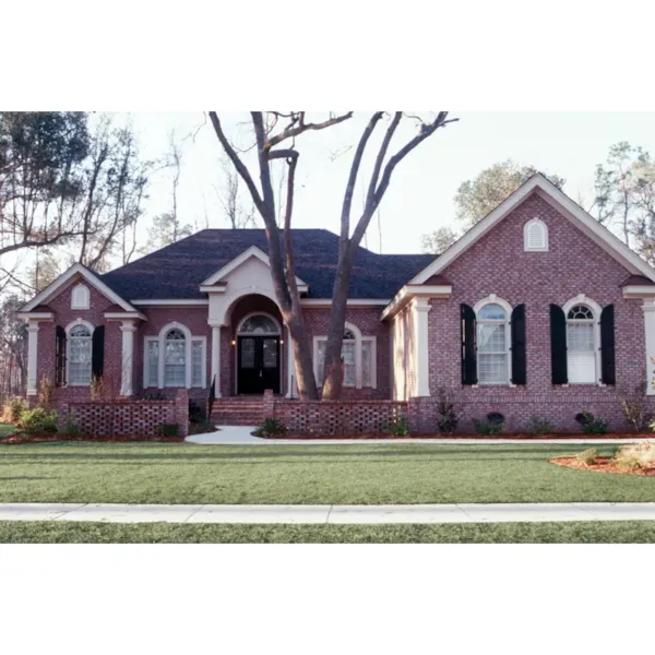 Striking Brick Ranch Home With Arched Entry And Windows