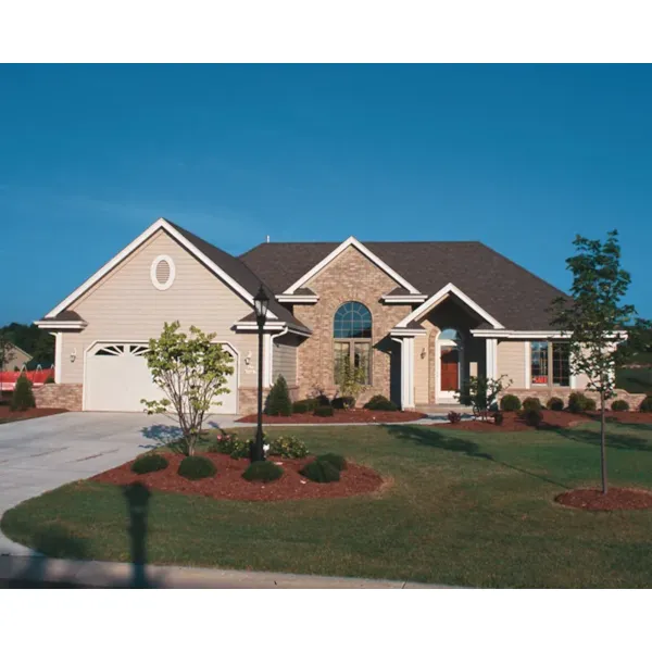 Traditional Ranch Home With Arch Window And Entry As Focal Point