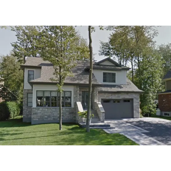 Tall Windows And Stone Accents Define This Traditional Home