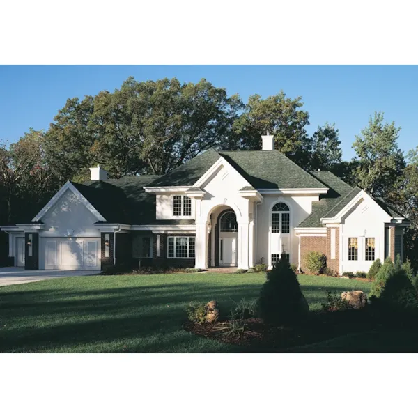 Two-Story Stucco Home With Grand Arched Front Entryway