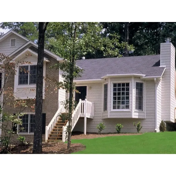 Relaxed Split-Level Home With Shuttered Windows And Siding