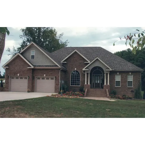 Traditional Brick Ranch Home Has Corner Quoins And Arched Front Entry