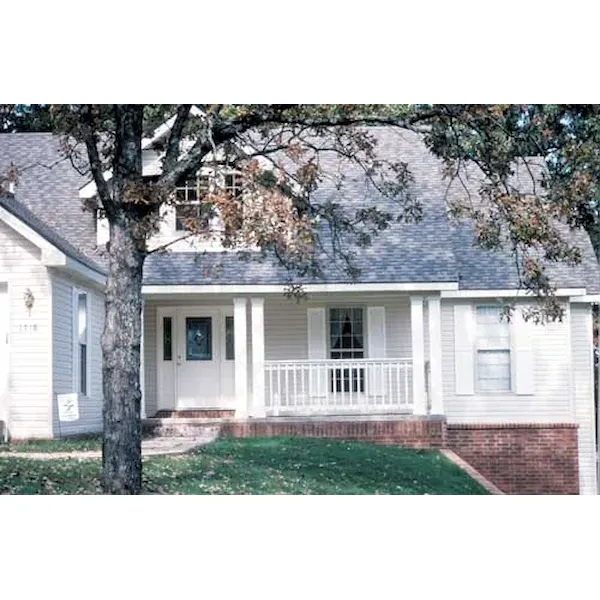 A Sizable Dormer Rests Above The Porch Of This Country Home