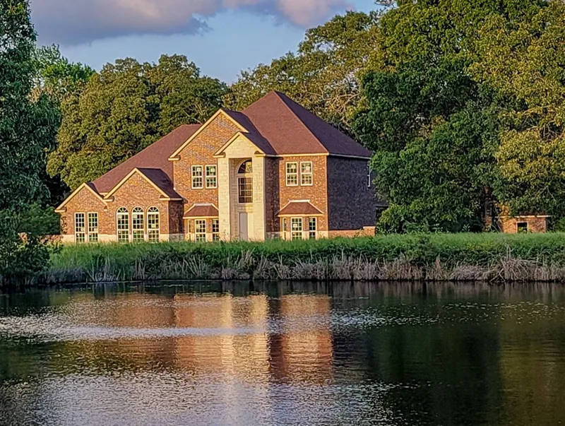 Spectacular Arched Foyer And Double Bay Windows Accentuate This Home