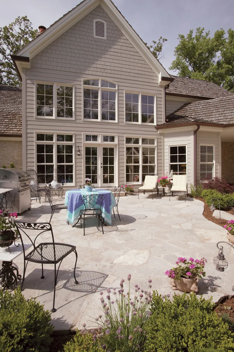 the oversized rear patio enjoys a striking backdrop of the great room’s massive window wall. With plenty of space for dining, relaxing or entertaining, this outdoor getaway is a convenient escape.