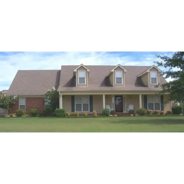 Country Style Home Is Topped With A Trio Of Dormers