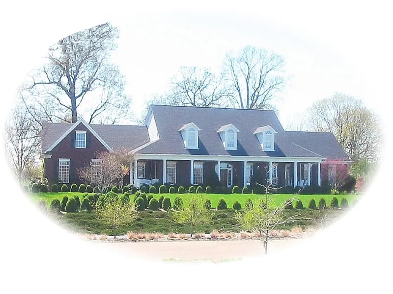 Country Style Home Has Triple Dormers And Covered Porch