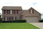 Traditional Two-Story Home With Brick Exterior And Front Loading Garage