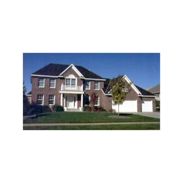 Colonial Style Home Features Balcony Above Entrance