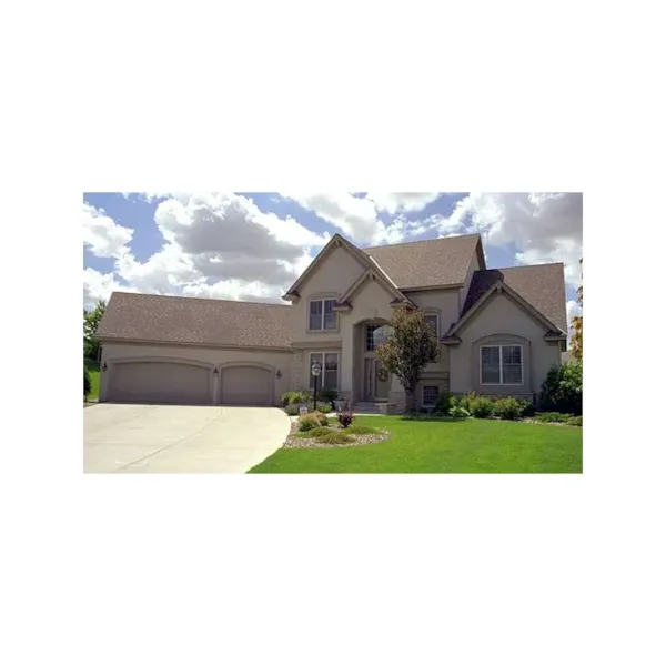 Traditional Two-Story House Has Angled Garage And Prominent Arched Entry