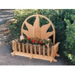 All wood ground level planter has sun shaped motif design on the back