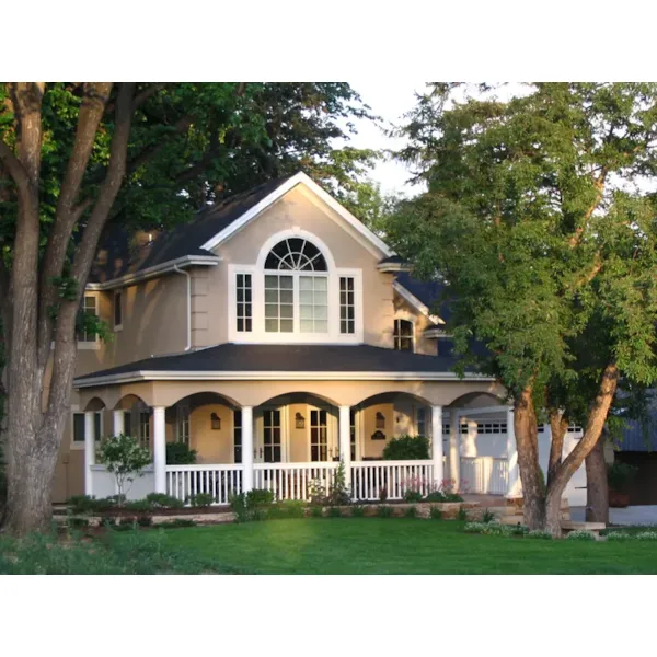 Country Home Has Large Covered Porch And Arch Window Above