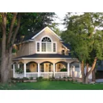 Country Home Has Large Covered Porch And Arch Window Above