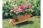Whelbarrow planter is made of redwood cedar and holds many plants and flowers