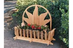 All wood ground level planter has sun shaped motif design on the back