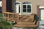 Low-level deck has a portion with a railing and shallow steps to the ground level